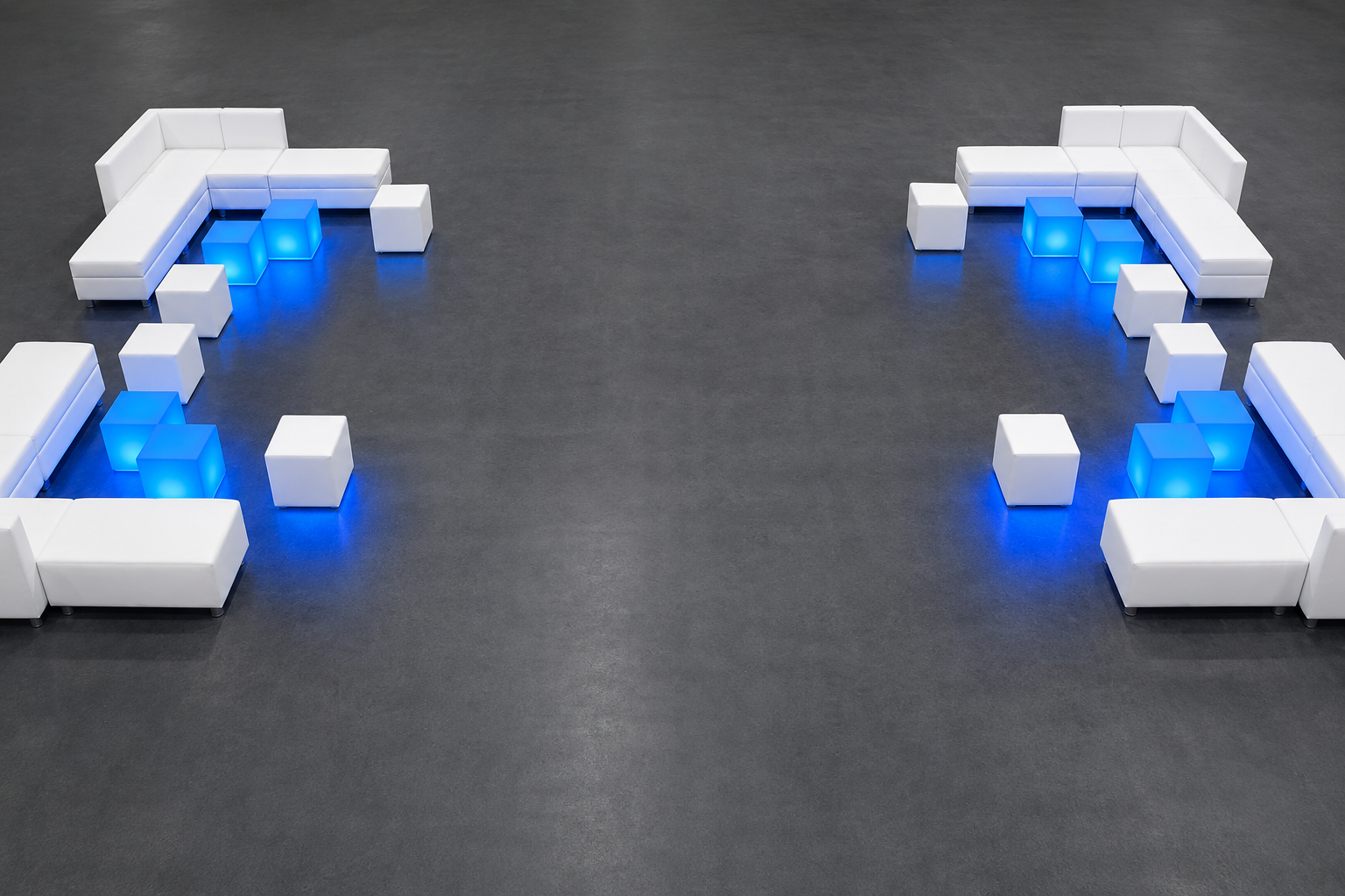 Symmetrical white modular lounge sets with blue LED glow cubes on a dark event floor